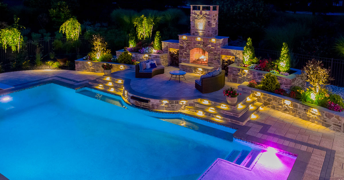 Luxury pool at night with sitting area