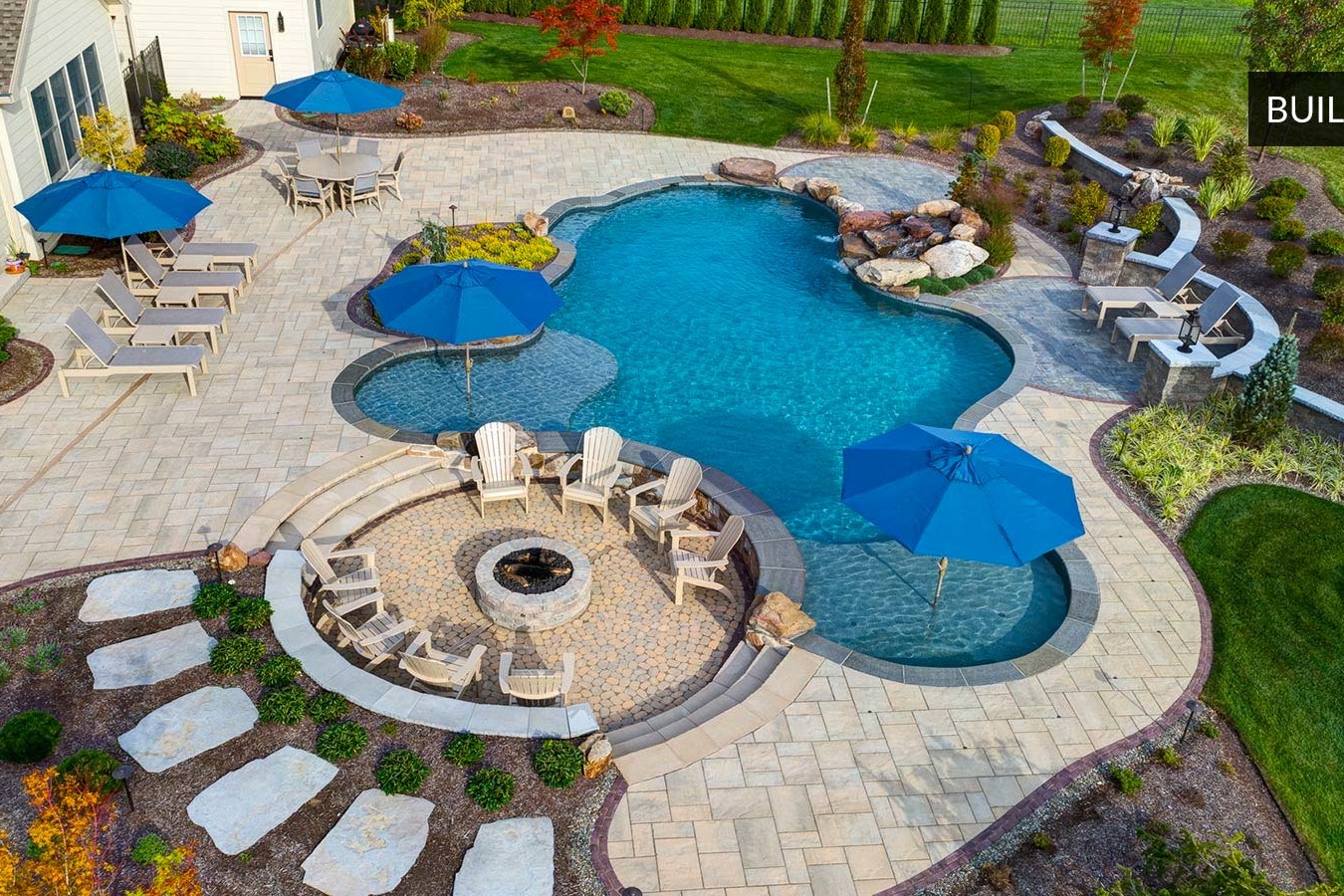 drone shot of backyard pool and fire pit