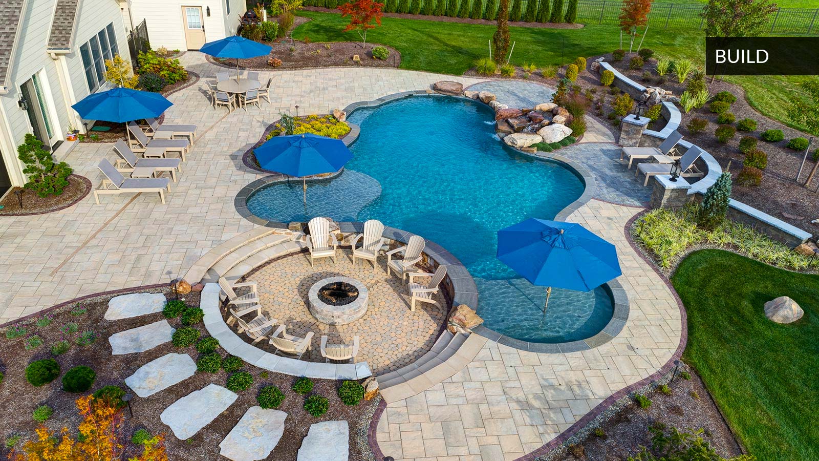 drone shot of backyard pool and fire pit